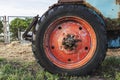 Red rusty wheel from a tractor close up Royalty Free Stock Photo