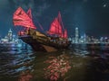 Red Sail Junk Boat on Victoria Harbour in Hong Kong Royalty Free Stock Photo