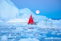 Red sailboat cruising among icebergs. Royalty Free Stock Photo