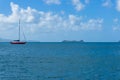 Red sailboat, yachts on calm sea