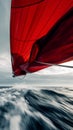 Red Sailing Spinnaker Against Stormy Sky