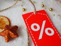 Sale winter, christmas orange star with discount label on festive background Royalty Free Stock Photo