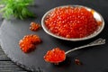 Red salmon caviar on black background Royalty Free Stock Photo