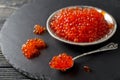 Red salmon caviar on black background Royalty Free Stock Photo