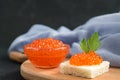 Red salmon caviar served with bread and parseley on wooden desk Royalty Free Stock Photo