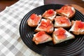 Red salmon on white bread. bagel and lox. view from above. black plate on a white background Royalty Free Stock Photo