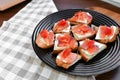 Red salmon on white bread. bagel and lox. view from above. black plate on a white background Royalty Free Stock Photo