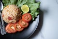 Red salted egg fried rice with vegetables in black plate Royalty Free Stock Photo