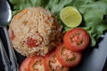 Red salted egg fried rice with vegetables in black plate Royalty Free Stock Photo