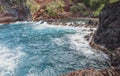 Red Sand Beach, Maui in in Hawaiian. Ocean waves and rock. Royalty Free Stock Photo