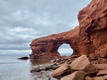 Red sandstone sea cliffs under an overcast sky at Cavendish Beach, Prince Edward Island, Canada. Royalty Free Stock Photo