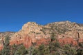 Red sandstone and white limestone mountain with trees in the foreground on the Brins Mesa Trail in Sedon Royalty Free Stock Photo