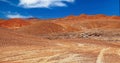 Red sandy dry arid barren valley, off orad tire tracks in sand, camper truck, mountains - Salar de Atacama, Chile