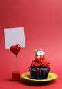 Red Santa Christmas festive cupcake with place card blank sign. Vertical.