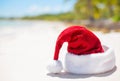 Red Santa Claus hat on beach, theme for Christmas vacation and travel Royalty Free Stock Photo