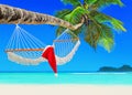 Red Santa Claus hat on hammock at palm island beach Royalty Free Stock Photo