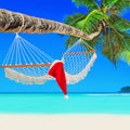 Red Santa Claus hat on hammock at palm island beach Royalty Free Stock Photo