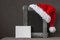 Red Santa Claus hat and an old wooden frame Royalty Free Stock Photo