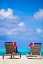 Red santa hat and Christmas stocking on chair Royalty Free Stock Photo