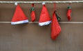 Red santa hat and gift hanging on brown wall Royalty Free Stock Photo