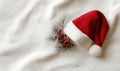 A red santa hat with a white pine branch on top of it Royalty Free Stock Photo