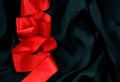 Red satin ribbon on black silk Royalty Free Stock Photo