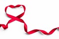 Red satin ribbon bow in heart shape isolated on white background clipping path, symbolic concept for National heart month