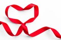 Red satin ribbon bow in heart shape isolated on white background clipping path, symbolic concept for National heart month