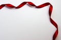 The red satin ribbon is in a corner of the page Royalty Free Stock Photo