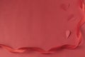 Red satin ribbon on a red background and heart. Valentine`s day. Love Royalty Free Stock Photo