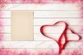 Red Satin Ribbon in Shape of Two Hearts on Wooden Background Royalty Free Stock Photo