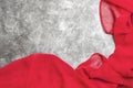 Red satin silk fabric on grey background. Copy space Royalty Free Stock Photo