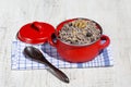 Red saucepan with kutia - traditional Christmas sweet meal in Ukraine, Belarus and Russia. Close up