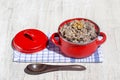 Red saucepan with kutia - traditional Christmas sweet meal in Ukraine, Belarus and Russia. Christmas kutya from wheat, poppy, waln