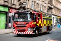 A red Scania P280 fire truck in the streets of Glasgow driving very quickly with a strong motion blur effect with focus on Scania