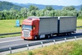 Red Scania truck coupled with trailer drived on slovak D1 highway in countryside. Royalty Free Stock Photo