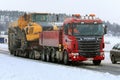 Red Scania Truck Transports Volvo Articulated Hauler