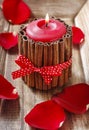 Red scented candle decorated with cinnamon sticks. Royalty Free Stock Photo