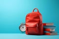 Red school backpack with books and a clock on a blue background. Generative AI Royalty Free Stock Photo