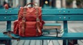 A red school backpack with books left on a bench in the school yard Royalty Free Stock Photo