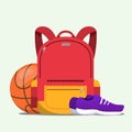 Red school bag with basketball and a pair of sport shoes isolated on a white background