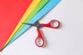 Red scissors and color sheets of paper on white background, flat lay Royalty Free Stock Photo