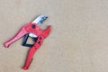 Red scissors for cutting plastic pipe Royalty Free Stock Photo