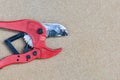 Red scissors for cutting plastic pipe