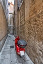 Red scooter in a narrow street, Croatia