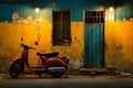 a red scooter parked in front of a yellow and blue building Royalty Free Stock Photo