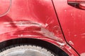 Red scratched car with damaged paint in crash accident on the street or collision on parking lot in the city Royalty Free Stock Photo