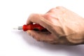 Red screwdriver in hand on a white background Royalty Free Stock Photo