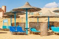 Red Sea Beach with Straw Umbrellas and Deck Chairs - Marsa Alam Egypt Africa Royalty Free Stock Photo