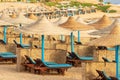 Red Sea Beach with Straw Umbrellas and Deck Chairs - Marsa Alam Egypt Africa Royalty Free Stock Photo